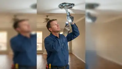 Houston electrician inspects ceiling box and support brace before chandelier installation