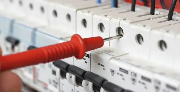 Electrical contractor testing circuit breakers during electrical repair in Missouri City, TX