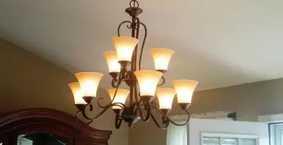 Classic ceiling chandelier installation with warm lighting in Houston, TX