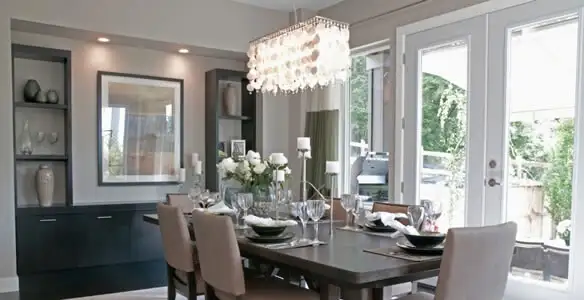 Elegant dining room chandelier installation above table in Houston, TX