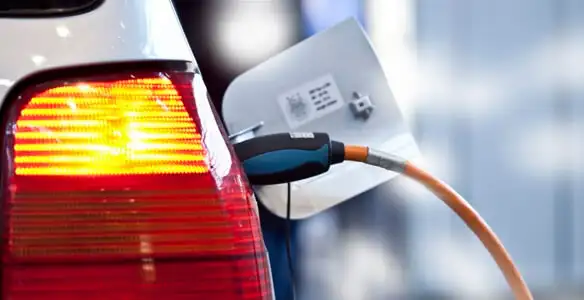 Electric car plugged into EV charger after professional installation in Houston, TX