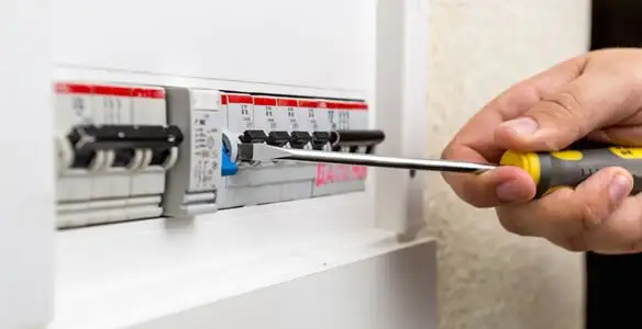 electrical panel upgrade service showing technician adjusting circuit breakers during system upgrade in Houston, TX