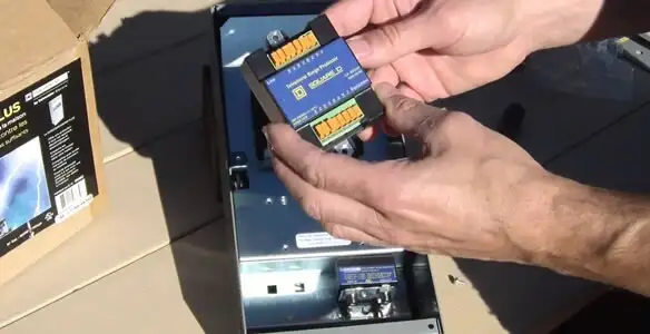 Electrician installing whole home surge protection unit inside main electrical panel in Houston, TX