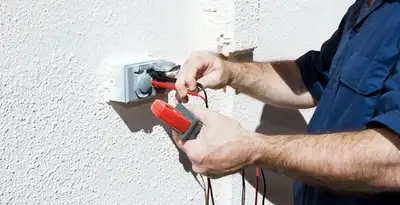 Electrician performing home electrical outlet and wiring inspection in Houston, TX