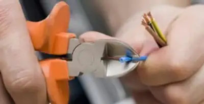 professional electrical services showing precise wire cutting by licensed electricians in Houston, TX