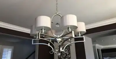 Modern chandelier installation with multiple light fixtures in Houston, TX