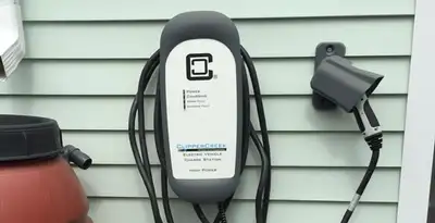 Outdoor electric vehicle charger installation on residential wall in Houston, TX