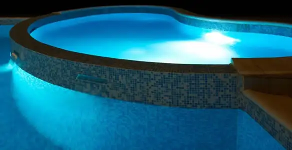 pool light installation and repair services highlighting illuminated pool interior lighting in Houston, TX
